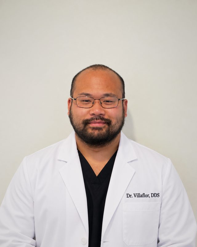 Dr. Chris Villaflor, DDS, in a white coat